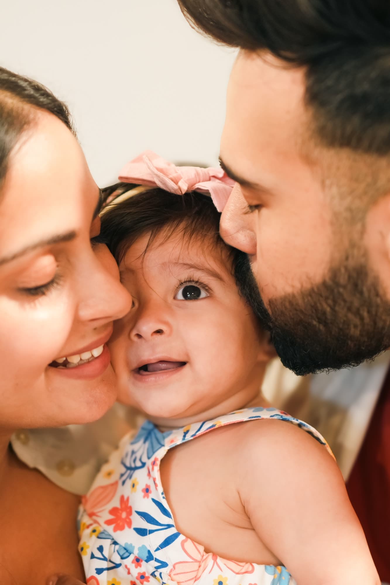 Parents holding their toddler close